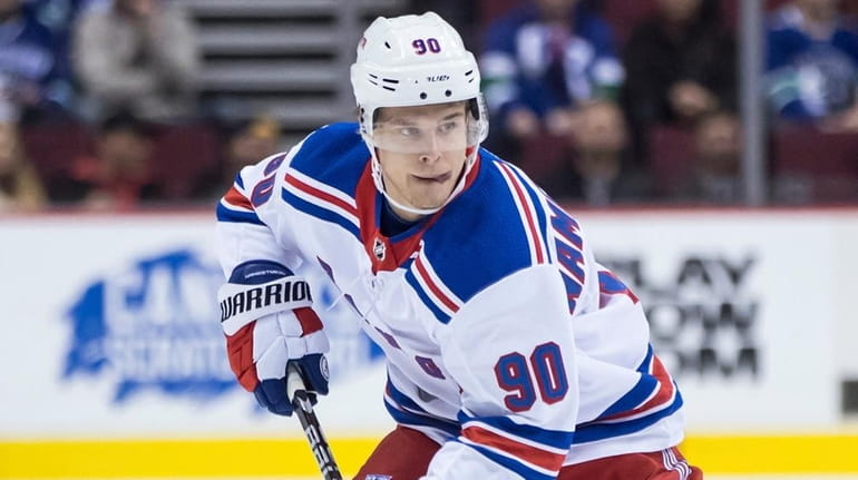 The Rangers' Vladislav Namestnikov skates with the puck past the...