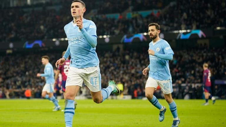 Manchester City's Phil Foden celebrates after scoring his side's second...