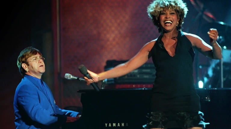 Tina Turner and Elton John perform a duet during the...
