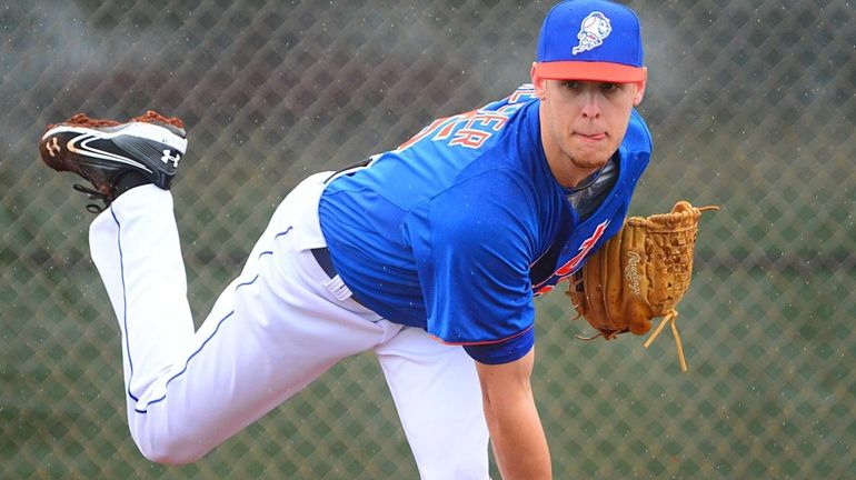 Zack Wheeler delivers a pitch during a spring training workout...