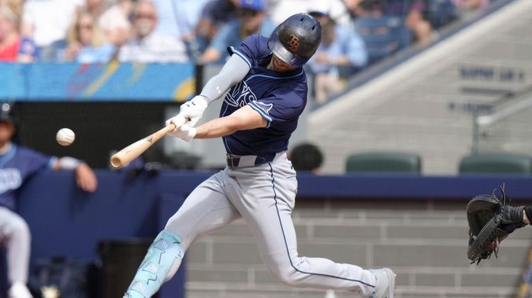 Tampa Bay Rays designated hitter Brandon Lowe hits an RBI...