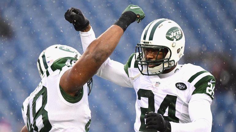 Darrelle Revis #24 of the New York Jets reacts with...