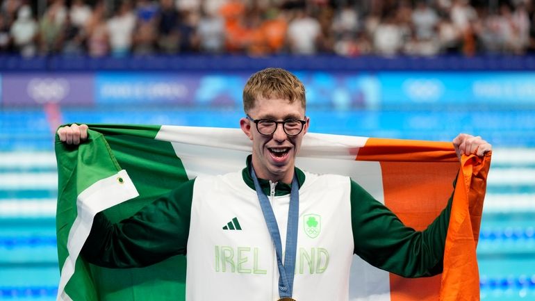 Gold medalist Daniel Wiffen, of Ireland, poses for a photo...