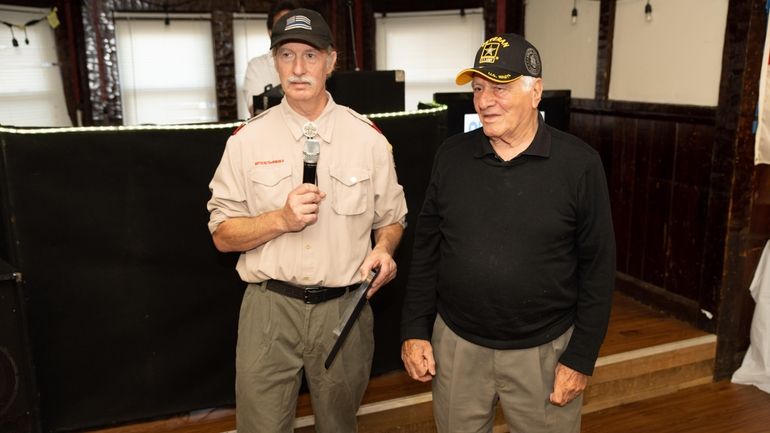 Steven Kopejzna from Bohemia, left, presents Aurelio Bilello, who earned a Purple...