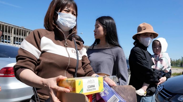 Members of Poland's Vietnamese community collect food donations, in Warsaw,...