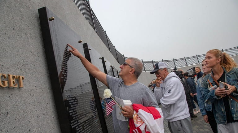 Matthew Graci at the memorial wall during the Town of...