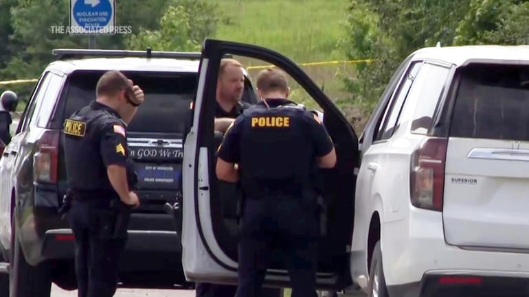 This image from video provided by KATV shows police officers...