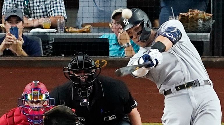 The Yankees' Aaron Judge connects for a solo home run,...