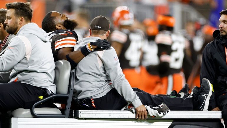 Cleveland Browns linebacker Anthony Walker Jr. (5) is taken off...