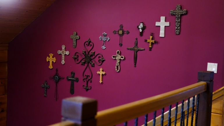 Crosses hang from one of the walls at the Rev....