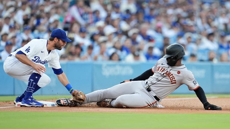 San Francisco Giants' Jorge Soler, right, is tagged out by...