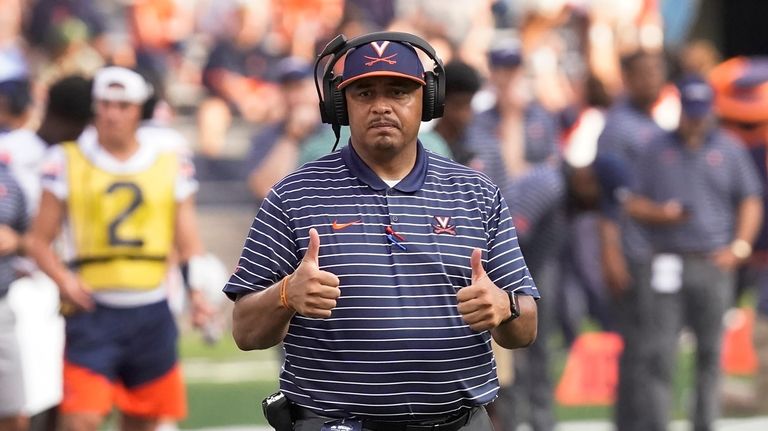 Virginia head coach Tony Elliott gestures on the field during...