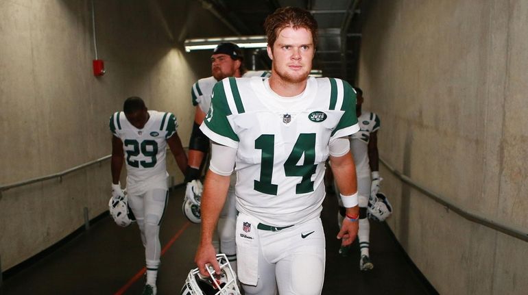 Sam Darnold of the Jets walks out of the tunnel...