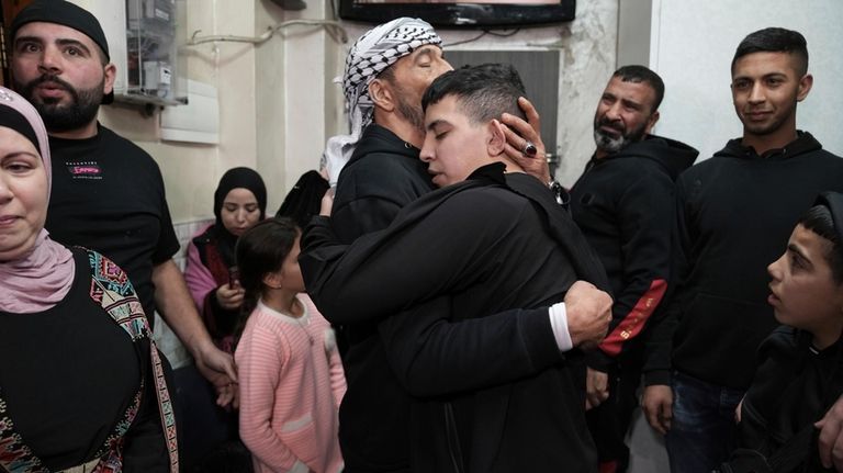 Ahmed Salaima, 14, center, a Palestinian prisoner released by Israel,...