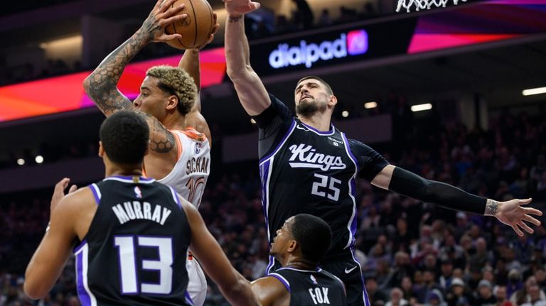 San Antonio Spurs forward Jeremy Sochan, top left, grabs a...