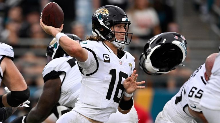 Jacksonville Jaguars quarterback Trevor Lawrence (16) throwsw a pass as...