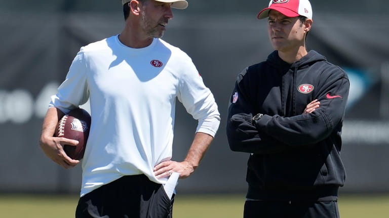 San Francisco 49ers head coach Kyle Shanahan, left, talks with...
