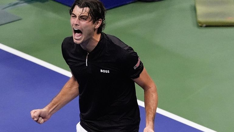 Taylor Fritz, of the United States, reacts after defeating Frances...