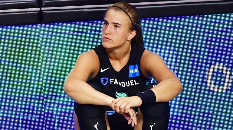 Sabrina Ionescu #20 of the Liberty looks on from the...