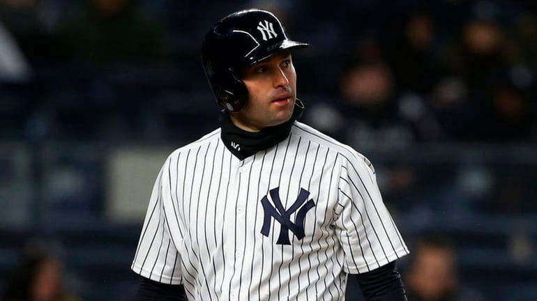 Neil Walker walks back to the Yankees' dugout after striking...