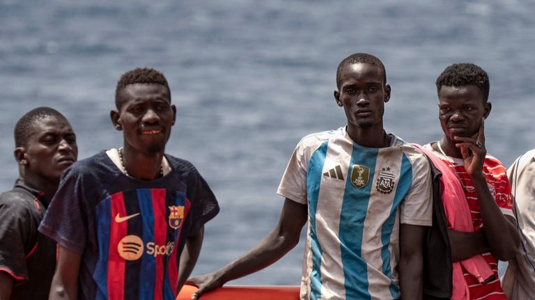 Migrants disembark at the port of "La Estaca" in Valverde...