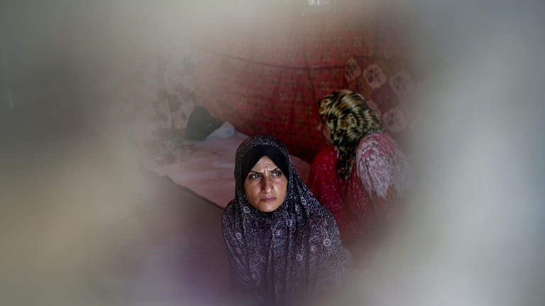 Ola Nassar, 41, who was displaced by the Israeli bombardment...