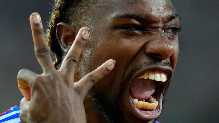 Noah Lyles, of the United States celebrates anchoring his team...