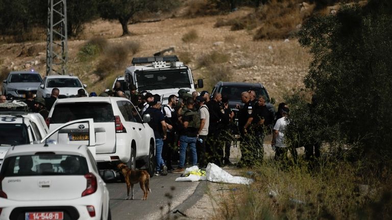 Israeli security forces and rescue services check the scene of...