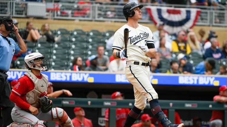 Minnesota Twins' Max Kepler, right, and Los Angeles Angels catcher...