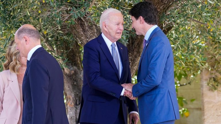 U.S. President Joe Biden, center, talks to Canada's Prime Minister...