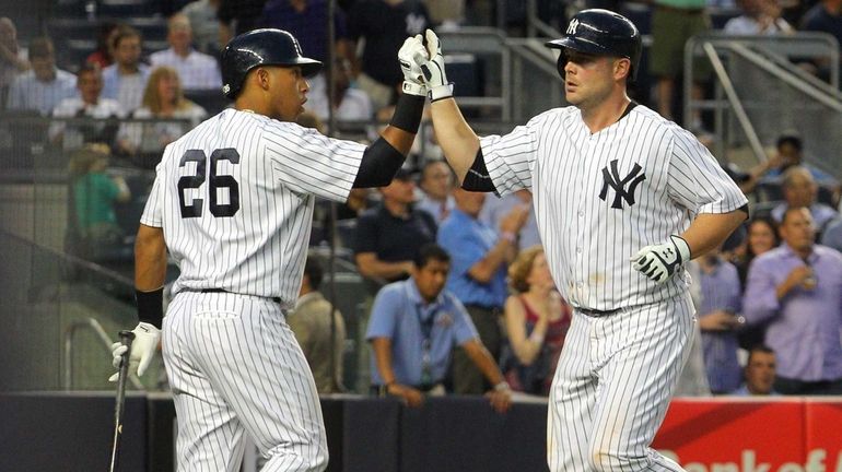 Yangervis Solarte congratulates Brian McCann after McCann's two-run home run...