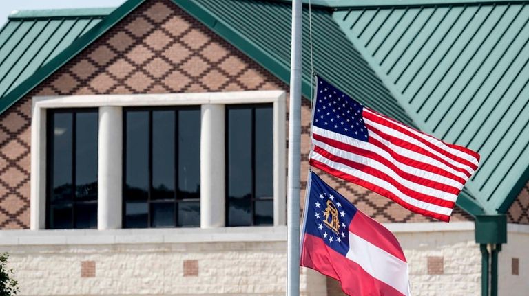 The American and state of Georgia flags fly half-staff after...