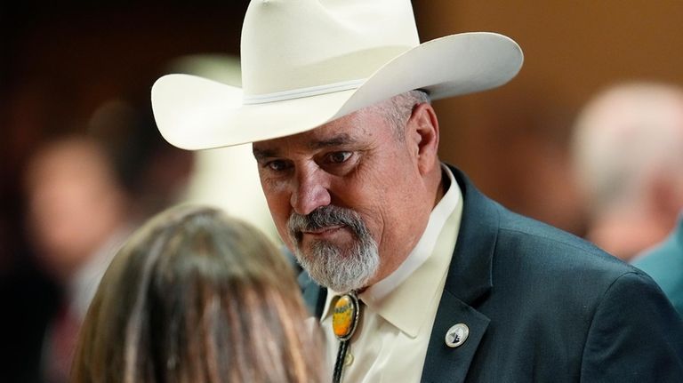 Colorado Rep. Richard Holtorf listens to an attendee before the...