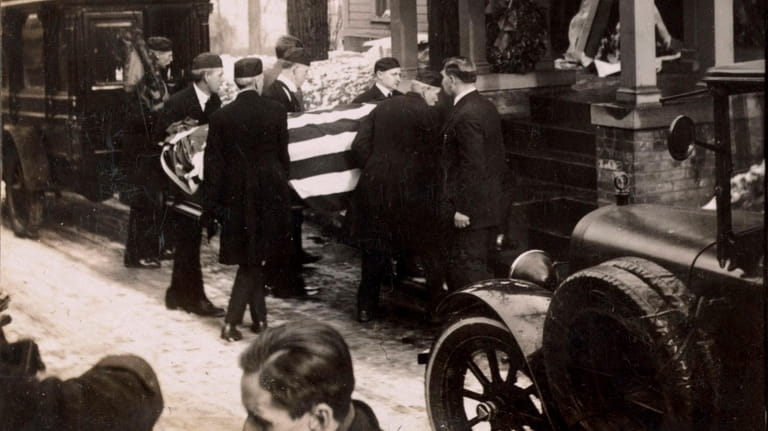 The coffin, draped in the flag Theodore Roosevelt loved, is...