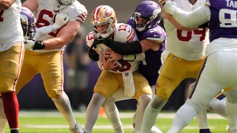 San Francisco 49ers quarterback Brock Purdy (13) is sacked by...