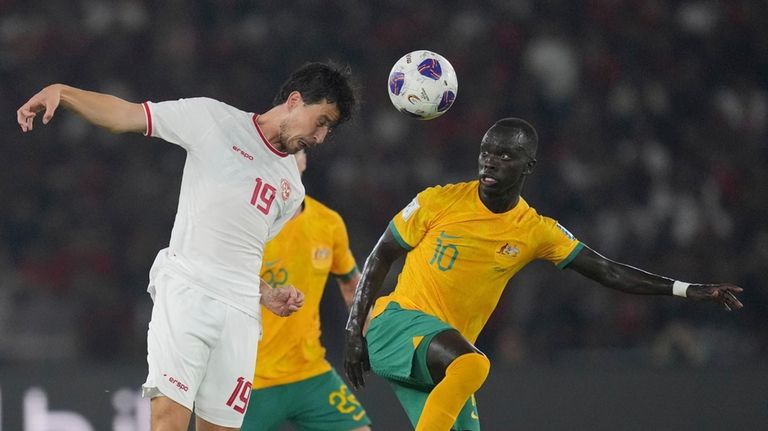 Indonesia's Thom Jan Haye, left, battles for the ball against...