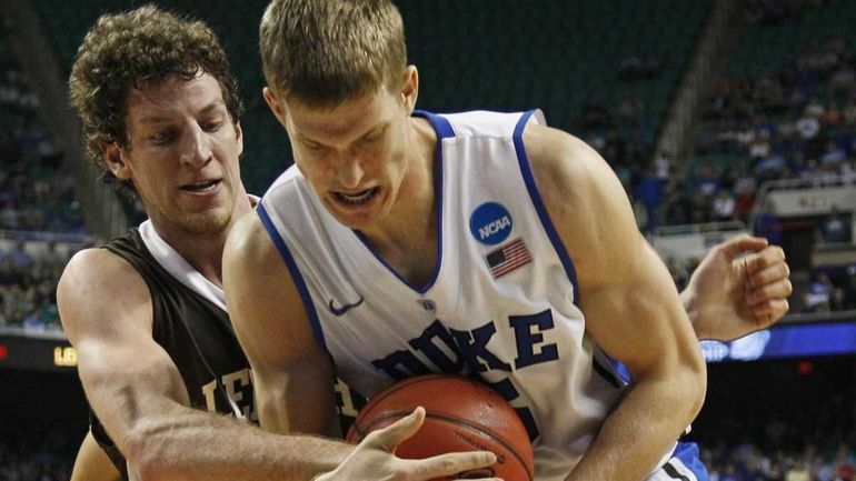 Duke's Mason Plumlee, right, and Lehigh's Gabe Knutson, left, battle...