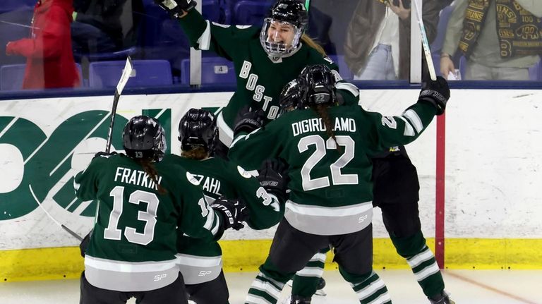 Boston forward Susanna Tapani, rear, celebrates her overtime goal against...