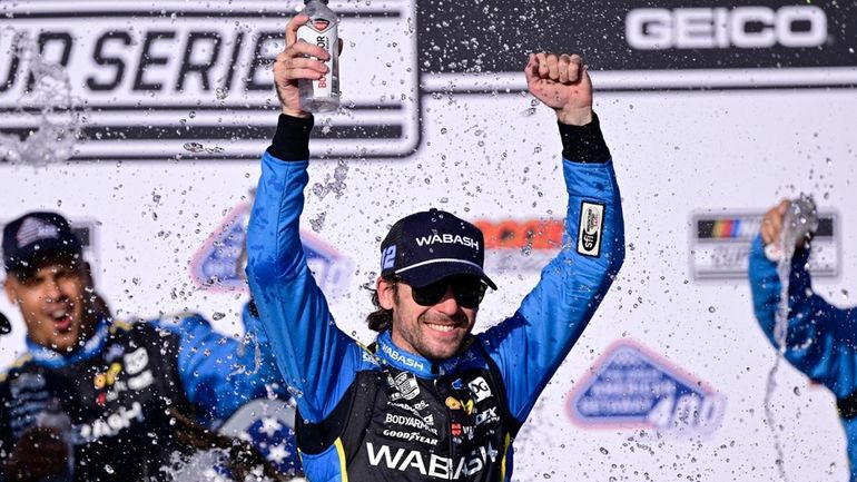 Ryan Blaney celebrates in the victory lane after winning a...