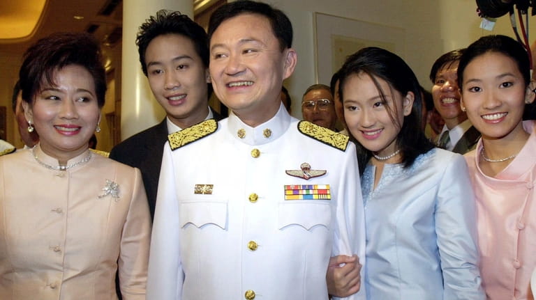 Newly-elected Thai Prime Minister Thaksin Shinawatra, center, is photographed with...