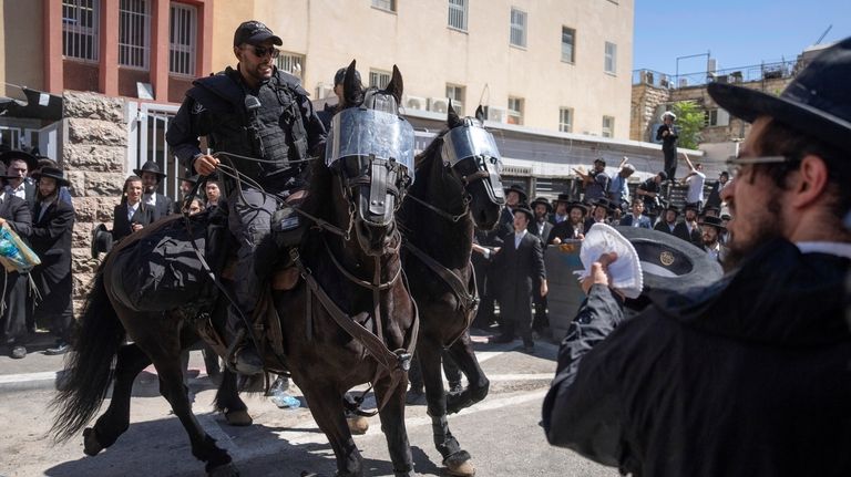 Israeli police officers scuffle with ultra-Orthodox Jewish men during a...