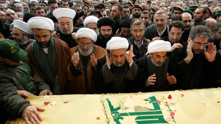 Hezbollah deputy leader Sheik Naim Kassem, third from right, prays...