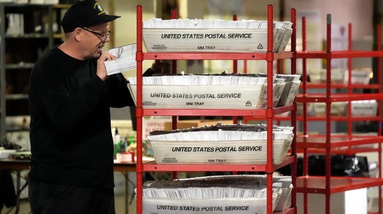 An Allegheny County worker processes mail-in and absentee ballots in...