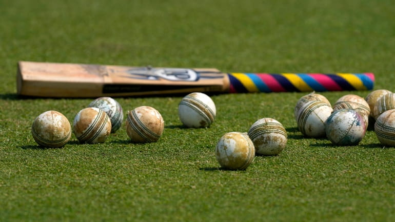 FILE -Cricket balls and a bat is seen on the...