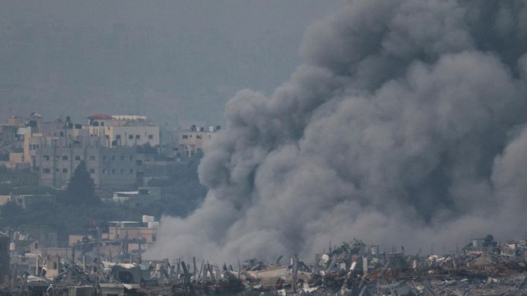 Smoke rises following an Israeli bombardment in the Gaza Strip,...