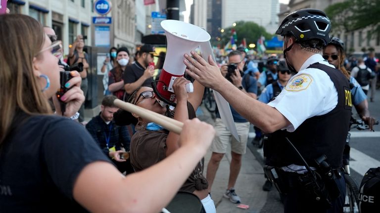 A police officer directs a protester during a march prior...