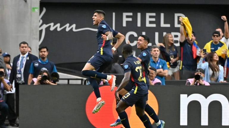 Ecuador players celebrate after an own goal from Jamaica's Kasey...