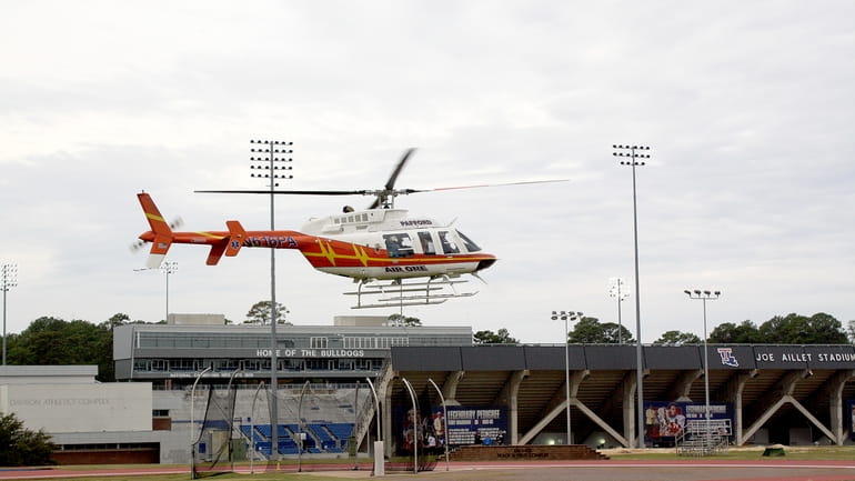 A Pafford EMS medical transport helicopter lifts off from outside...
