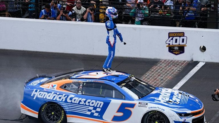 Kyle Larson celebrates after winning a NASCAR Cup Series auto...