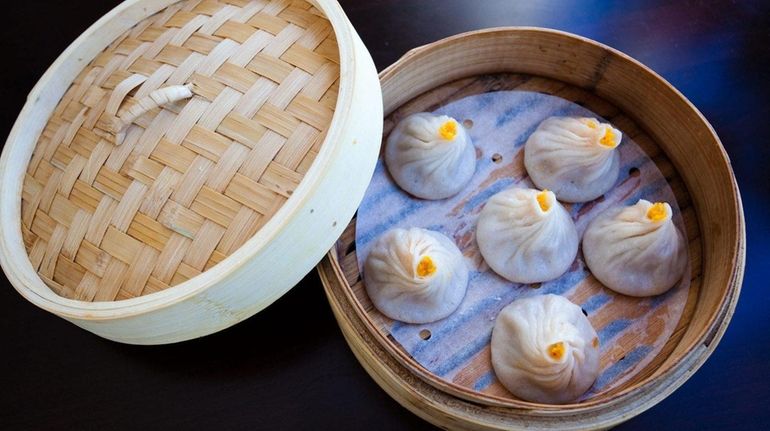 Steamed crabmeat and pork soup buns are served at the...